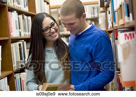 Stock Photo - Young couple in library. Fotosearch