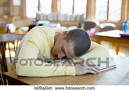 Young man asleep on book View Large Photo Image Stock Image - Young man asleep on book. Fotosearch