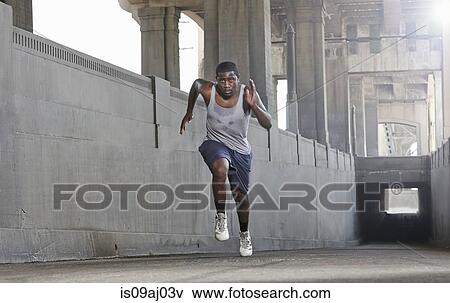 Stock Photo - Young man speed running over city bridge. Fotosearch