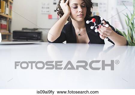 Young woman contemplating molecular model of Ethanol molecule View Large Photo Image Stock Photo - Young woman contemplating molecular model of Ethanol molecule. Fotosearch