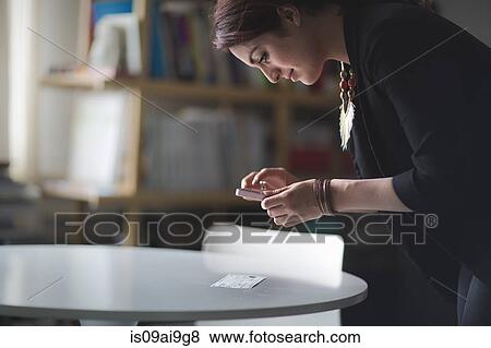 Young woman depositing cheque with smartphone View Large Photo Image Stock Photo - Young woman depositing cheque with smartphone. Fotosearch