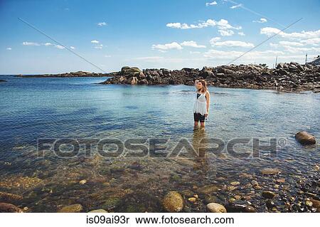 Young woman in the sea at the rocky coastal beach in Biddeford, Maine, USA View Large Photo Image Stock Photography - Young woman in the sea at the rocky coastal beach in Biddeford, Maine, USA. Fotosearch