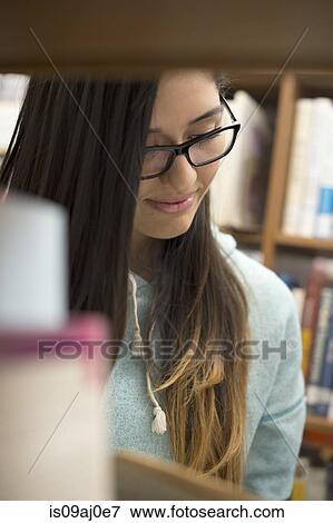 Stock Photo - Young woman reading book. Fotosearch