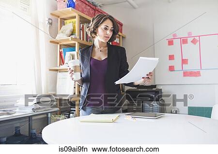 Young woman studying notes during coffee break View Large Photo Image Picture - Young woman studying notes during coffee break. Fotosearch