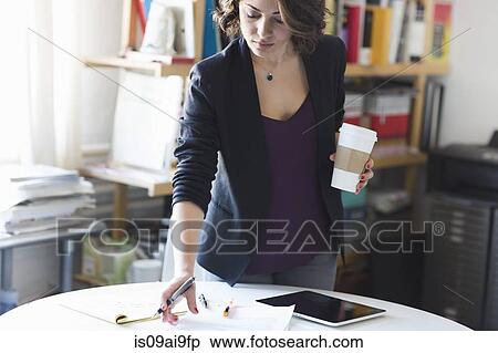 Young woman studying notes during coffee break View Large Photo Image Stock Photography - Young woman studying notes during coffee break. Fotosearch