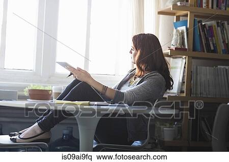 Young woman using digital tablet at coffee break View Large Photo Image Stock Photography - Young woman using digital tablet at coffee break. Fotosearch