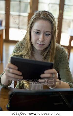 Young woman using digital tablet View Large Photo Image Picture - Young woman using digital tablet. Fotosearch