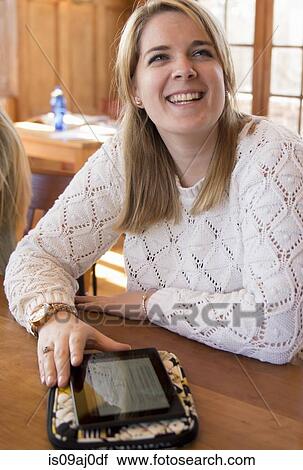 Stock Image - Young woman using digital tablet. Fotosearch