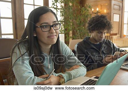 Young woman using laptop View Large Photo Image Stock Photo - Young woman using laptop. Fotosearch