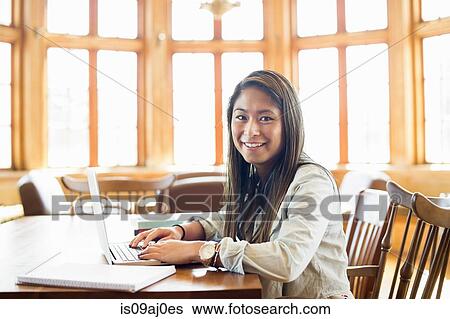 Young woman using laptop View Large Photo Image Stock Photograph - Young woman using laptop. Fotosearch