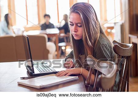 Young woman using laptop View Large Photo Image Stock Photography - Young woman using laptop. Fotosearch