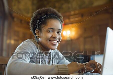 Young woman using laptop View Large Photo Image Stock Photography - Young woman using laptop. Fotosearch