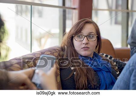 Stock Image - Young woman wearing glasses. Fotosearch