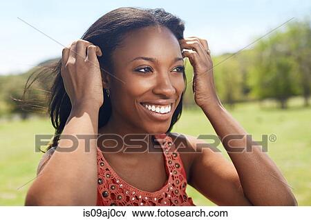 Young woman with hands in her hair View Large Photo Image Stock Photo - Young woman with hands in her hair. Fotosearch