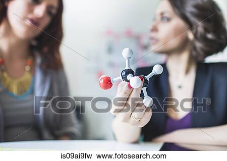 Young women discussing molecular model of Ethanol molecule View Large Photo Image Stock Photo - Young women discussing molecular model of Ethanol molecule. Fotosearch