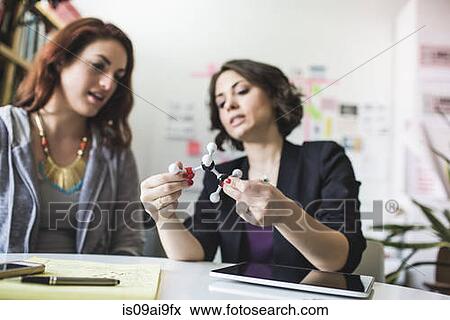 Young women discussing molecular model of Ethanol molecule View Large Photo Image Stock Photo - Young women discussing molecular model of Ethanol molecule. Fotosearch