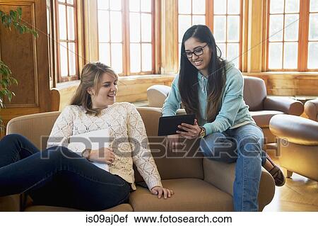 Young women using digital tablet View Large Photo Image Stock Image - Young women using digital tablet. Fotosearch