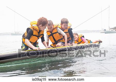 Brothers and sister about to fall from paddleboard into sea View Large Photo Image Stock Image - Brothers and sister about to fall from paddleboard into sea. Fotosearch