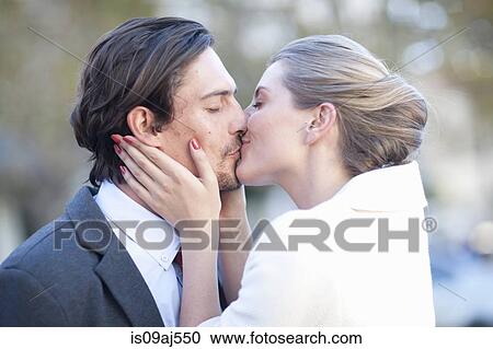 Businessman and woman kissing on city street View Large Photo Image Stock Image - Businessman and woman kissing on city street. Fotosearch