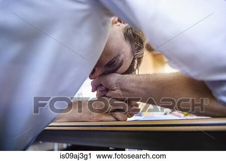 Businessman head down exhausted on table View Large Photo Image Stock Image - Businessman head down exhausted on table. Fotosearch