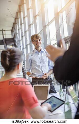 Stock Photo - Businessman presenting to business people. Fotosearch