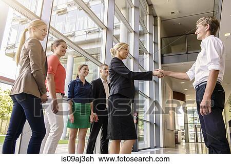 Businessmen and businesswomen at end of agreeable meeting View Large Photo Image Stock Image - Businessmen and businesswomen at end of agreeable meeting. Fotosearch