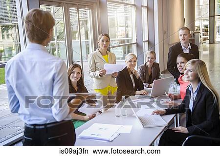 Businessmen and businesswomen at brainstorming meeting View Large Photo Image Picture - Businessmen and businesswomen at brainstorming meeting. Fotosearch