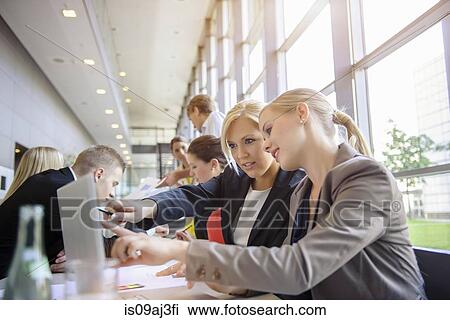 Businessmen and businesswomen at brainstorming meeting View Large Photo Image Stock Image - Businessmen and businesswomen at brainstorming meeting. Fotosearch