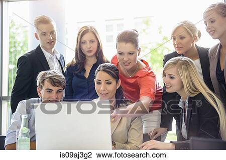 Businessmen and businesswomen at brainstorming meeting View Large Photo Image Stock Image - Businessmen and businesswomen at brainstorming meeting. Fotosearch