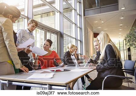 Businessmen and businesswomen at brainstorming meeting View Large Photo Image Stock Photo - Businessmen and businesswomen at brainstorming meeting. Fotosearch