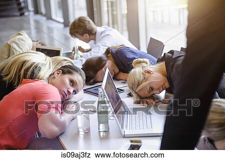 Businessmen and businesswomen exhausted at brainstorm meeting View Large Photo Image Stock Photo - Businessmen and businesswomen exhausted at brainstorm meeting. Fotosearch