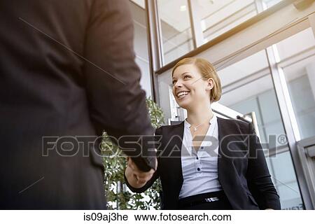 Stock Image - Businesswoman meeting client in office. Fotosearch