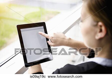 Businesswoman using digital tablet touchscreen View Large Photo Image Stock Image - Businesswoman using digital tablet touchscreen. Fotosearch