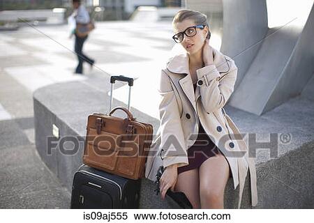 Stock Photography - Businesswoman waiting on city rooftop parking lot. Fotosearch
