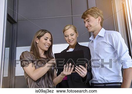 Businesswomen and businessman using digital tablet for discussion View Large Photo Image Stock Photo - Businesswomen and businessman using digital tablet for discussion. Fotosearch