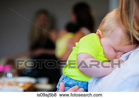 Close up of baby boy asleep on mother's shoulder View Large Photo Image Stock Photo - Close up of baby boy asleep on mother's shoulder. Fotosearch
