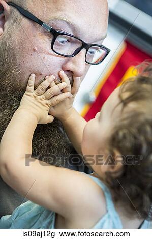 Close up of baby girl with hands over man's mouth View Large Photo Image Stock Image - Close up of baby girl with hands over man's mouth. Fotosearch