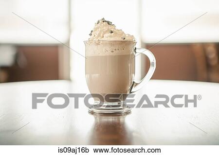 Stock Image - Close up of hot chocolate with whipped cream in cafe. Fotosearch