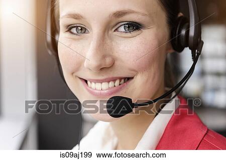 Close up of young businesswoman using telephone headset View Large Photo Image Stock Photo - Close up of young businesswoman using telephone headset. Fotosearch