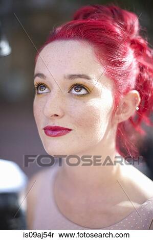 Stock Photography - Close up portrait of young woman with pink hair. Fotosearch