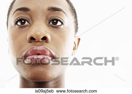 Stock Image - Close up studio portrait of sad young woman. Fotosearch