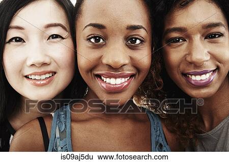 Stock Photograph - Close up studio portrait of three smiling young women. Fotosearch