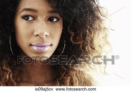 Stock Photo - Close up studio portrait of young woman glancing sideways. Fotosearch