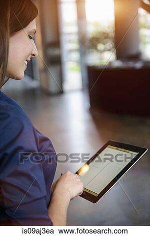 Cropped view of young businesswoman using digital tablet in office View Large Photo Image Stock Image - Cropped view of young businesswoman using digital tablet in office. Fotosearch