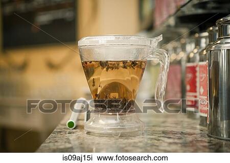 Cup of herbal tea on cafe counter View Large Photo Image Stock Image - Cup of herbal tea on cafe counter. Fotosearch