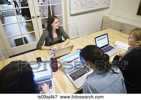 Female colleagues in a meeting with laptops View Large Photo Image Stock Photo - Female colleagues in a meeting with laptops. Fotosearch