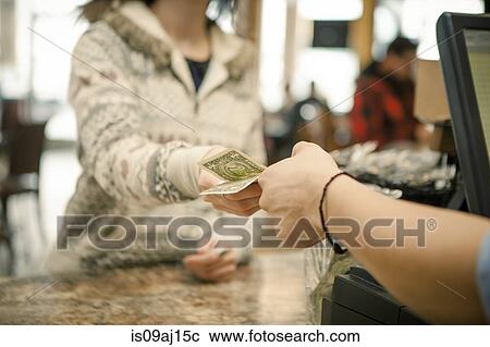 Female customer handing payment to waiter over cafe counter View Large Photo Image Stock Image - Female customer handing payment to waiter over cafe counter. Fotosearch