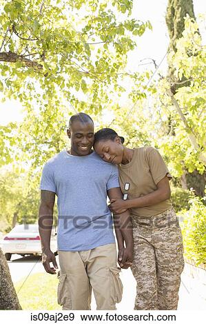 Female soldier resting head on husbands shoulder whilst strolling on homecoming View Large Photo Image Stock Photo - Female soldier resting head on husbands shoulder whilst strolling on homecoming. Fotosearch