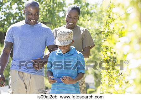 Female soldier strolling with family on homecoming View Large Photo Image Stock Image - Female soldier strolling with family on homecoming. Fotosearch