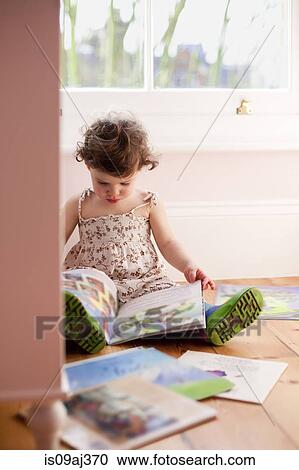 Female toddler reading storybooks in bedroom View Large Photo Image Stock Image - Female toddler reading storybooks in bedroom. Fotosearch
